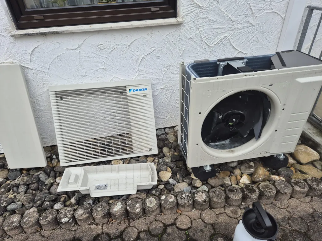 Zerlegtes Daikin-Außengerät bei der Wartung, die Abdeckungen liegen daneben